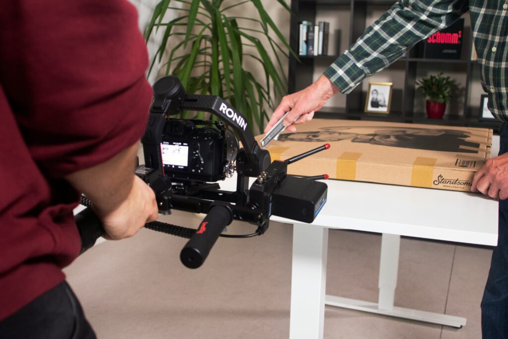 A cameraman films and influencer making an e-commerce product video.