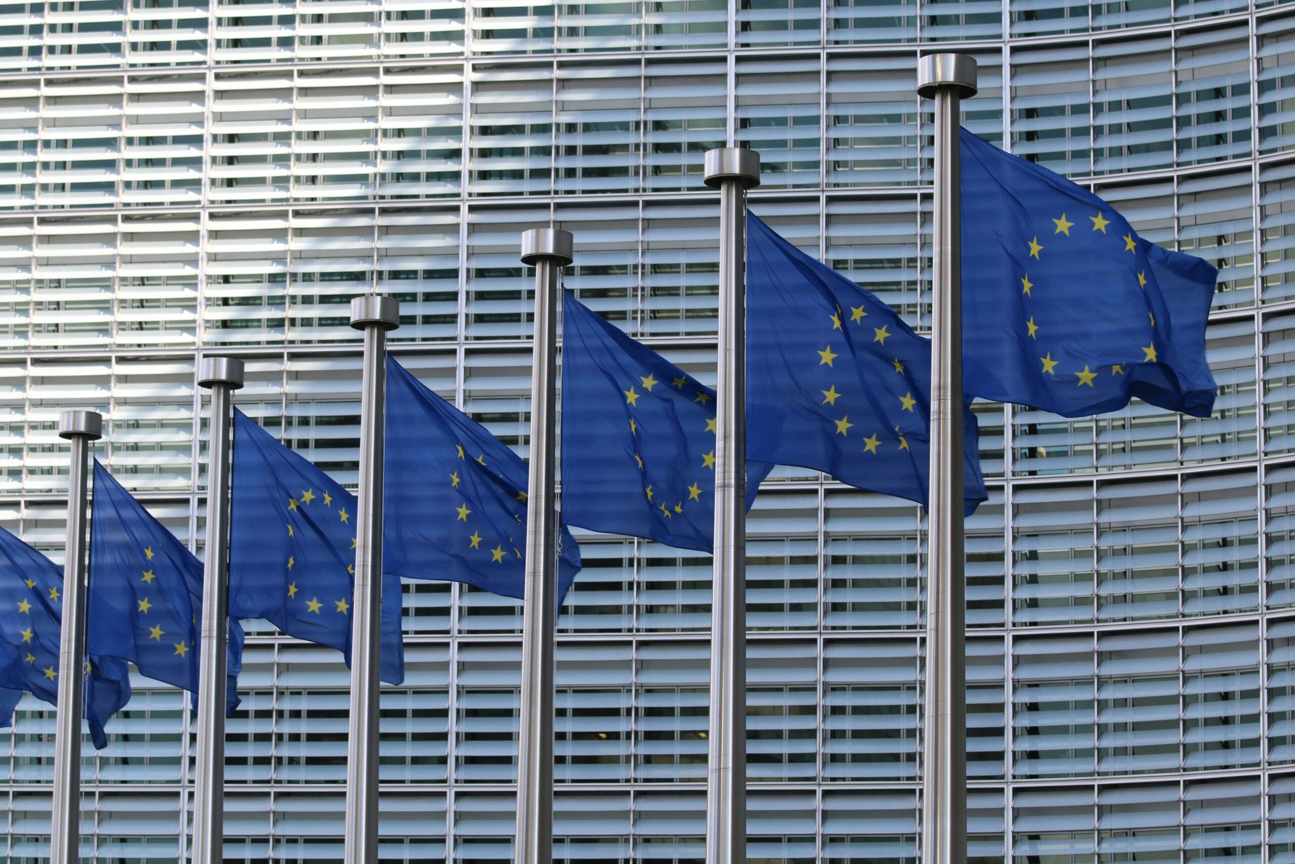 Flags of Europe fly in front of the European Commission building.