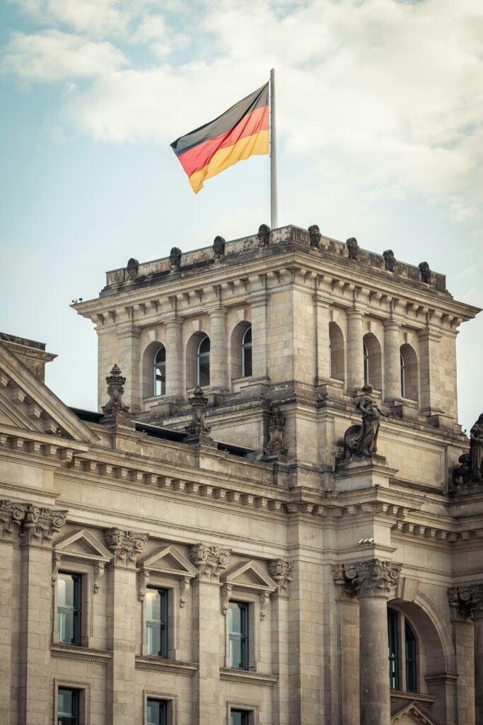 The German flag flies on top of the Bundestag, where the European Accessibility Act in Germany was transposed into the BFSG.