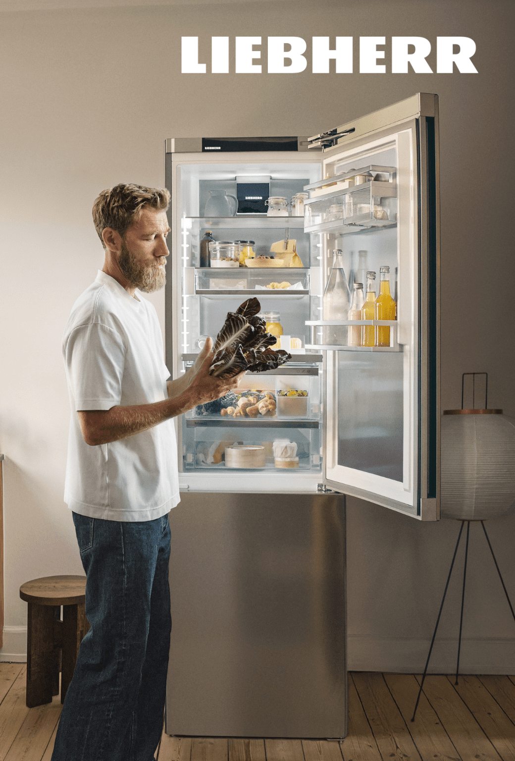 A man stands in front of a Liebherr refrigerator.